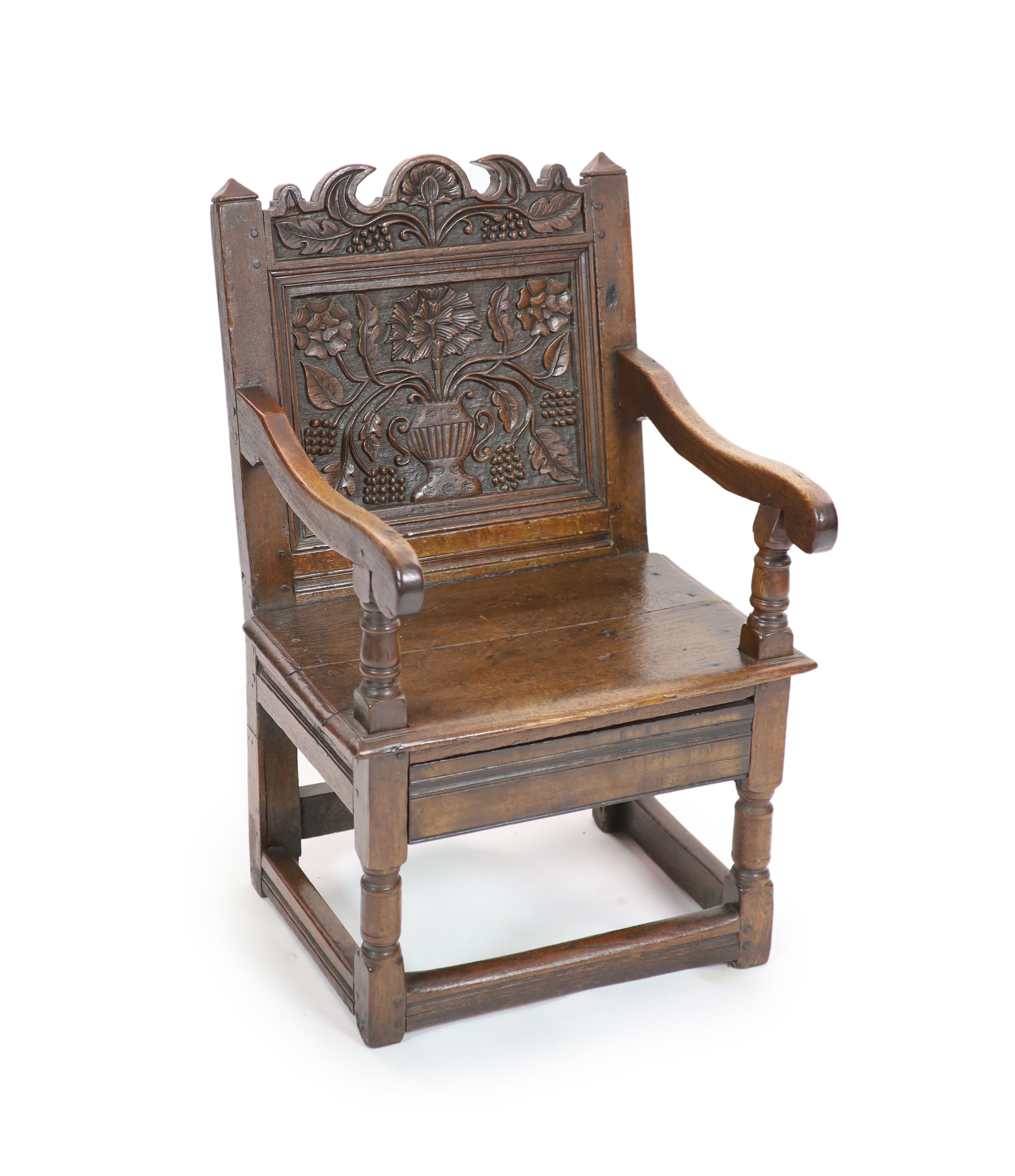 A South Lancashire/North Cheshire Charles II carved and panelled oak open armchair H 93cm. W 60cm. D 53cm.